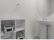 Contemporary bathroom featuring pedestal sink, storage shelves, and a minimalist design at 1121 Blue Jay Dr, Davenport, FL 33837