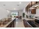 Open kitchen with granite counters seamlessly connecting to the living area with views of the lake at 1121 Blue Jay Dr, Davenport, FL 33837