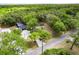 Aerial view of the property showcasing its expansive wooded surroundings and a private pool area at 120 W Trade Winds Rd, Winter Springs, FL 32708