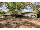 Large backyard featuring a screened-in pool and lush green trees, perfect for outdoor entertaining at 120 W Trade Winds Rd, Winter Springs, FL 32708