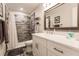 Renovated bathroom boasts a marble vanity, stylish mirror, and tiled shower with updated fixtures at 120 W Trade Winds Rd, Winter Springs, FL 32708