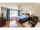Comfortable bedroom with a large window, wood furniture, and blue accents at 120 W Trade Winds Rd, Winter Springs, FL 32708
