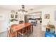 Bright dining area leading into the kitchen, featuring a large wooden table and white cabinetry at 120 W Trade Winds Rd, Winter Springs, FL 32708