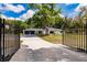 View of the home from gated driveway entrance at 120 W Trade Winds Rd, Winter Springs, FL 32708