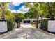 View of the home from gated driveway entrance at 120 W Trade Winds Rd, Winter Springs, FL 32708