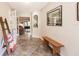 Inviting entryway featuring tile floors, a wooden bench, and a decorative mirror at 120 W Trade Winds Rd, Winter Springs, FL 32708