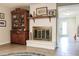 Close-up of the living room fireplace, surrounded by decorative items and a wooden shelf at 120 W Trade Winds Rd, Winter Springs, FL 32708