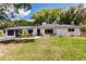 Charming front yard with brick accents, flowers, and a well-kept lawn at 120 W Trade Winds Rd, Winter Springs, FL 32708