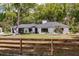 Charming single story home featuring a manicured front yard and a rustic wooden fence at 120 W Trade Winds Rd, Winter Springs, FL 32708