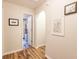 Bright hallway with wood floors leads to a bathroom with a white shower curtain at 120 W Trade Winds Rd, Winter Springs, FL 32708