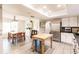 Bright kitchen with white cabinets, stainless steel appliances and a center table and adjacent dining area at 120 W Trade Winds Rd, Winter Springs, FL 32708