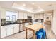 Modern kitchen with white cabinets, stainless steel appliances, and an island with bar stools at 120 W Trade Winds Rd, Winter Springs, FL 32708