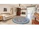 Inviting living room featuring a fireplace, a comfortable couch, and a decorative rug at 120 W Trade Winds Rd, Winter Springs, FL 32708
