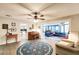 Open living room with tile floors, a ceiling fan, and sliding glass doors to an enclosed patio at 120 W Trade Winds Rd, Winter Springs, FL 32708