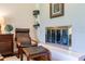 Cozy sitting area featuring an electric fireplace and a leather chair with footrest at 120 W Trade Winds Rd, Winter Springs, FL 32708