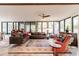 Bright sunroom with large windows, comfortable seating, and decorative rug at 120 W Trade Winds Rd, Winter Springs, FL 32708