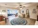 Bright living room with a ceiling fan, a floral rug, and sliding doors to the patio at 120 W Trade Winds Rd, Winter Springs, FL 32708