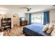 Bright main bedroom features wood floors, ceiling fan, and a view to the outside at 120 W Trade Winds Rd, Winter Springs, FL 32708