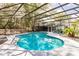 Inviting pool with screened enclosure, a deck and mature trees at 120 W Trade Winds Rd, Winter Springs, FL 32708