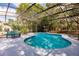 Sparkling pool with a screened in enclosure, deck and mature trees at 120 W Trade Winds Rd, Winter Springs, FL 32708