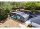 Aerial view of a screened pool area and lush, landscaped backyard at 120 W Trade Winds Rd, Winter Springs, FL 32708