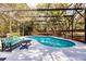 Screened-in kidney-shaped pool with patio seating at 120 W Trade Winds Rd, Winter Springs, FL 32708