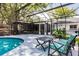 Relaxing screened pool area with comfortable seating and a built-in bar for entertaining friends and Gathering at 120 W Trade Winds Rd, Winter Springs, FL 32708