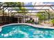 Backyard pool with screened enclosure, deck and mature trees at 120 W Trade Winds Rd, Winter Springs, FL 32708