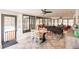 Open sunroom with dining table, seating area, and views of the backyard at 120 W Trade Winds Rd, Winter Springs, FL 32708