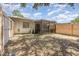 View of the backyard showing a screened porch and wood fence providing privacy at 1230 Westside Dr, Winter Garden, FL 34787