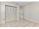 This bedroom features tiled floors, a closet, and an entrance to another room at 1230 Westside Dr, Winter Garden, FL 34787
