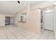 Open-concept living room and kitchen area with tile flooring and a breakfast bar at 1230 Westside Dr, Winter Garden, FL 34787