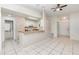 Open-concept living room and kitchen area with tile flooring and a breakfast bar at 1230 Westside Dr, Winter Garden, FL 34787