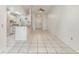 Open-concept living room and kitchen area with tile flooring and a breakfast bar at 1230 Westside Dr, Winter Garden, FL 34787