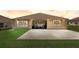 Home's exterior showcasing a spacious patio and manicured lawn, perfect for outdoor living at 12711 Se 97Th Terrace Rd, Summerfield, FL 34491
