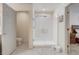 Bright bathroom with modern glass-enclosed shower and tile flooring, offering a clean and functional space at 12711 Se 97Th Terrace Rd, Summerfield, FL 34491