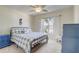 Comfortable bedroom with natural light, ceiling fan, and a stylish blue accent furniture set at 12711 Se 97Th Terrace Rd, Summerfield, FL 34491