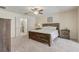 Relaxing main bedroom featuring plush carpeting, ceiling fan, and ensuite bathroom at 12711 Se 97Th Terrace Rd, Summerfield, FL 34491