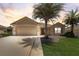 Charming single-story home with a well-manicured lawn and mature palm trees at 12711 Se 97Th Terrace Rd, Summerfield, FL 34491