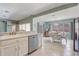 Bright kitchen featuring stainless steel appliances and a breakfast bar overlooking the dining area at 12711 Se 97Th Terrace Rd, Summerfield, FL 34491