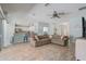 Open-concept living area with tile flooring, a modern ceiling fan and access to the kitchen at 12711 Se 97Th Terrace Rd, Summerfield, FL 34491