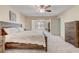 Spacious main bedroom boasts soft carpet, ceiling fan, and natural light from a picture window at 12711 Se 97Th Terrace Rd, Summerfield, FL 34491