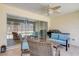 Inviting covered patio with comfortable seating and a ceiling fan, great for outdoor relaxation at 12711 Se 97Th Terrace Rd, Summerfield, FL 34491