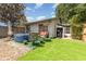 Backyard view with patio, artificial turf, storage shed, and hot tub at 1303 Azalea Way, Winter Garden, FL 34787