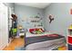 The bedroom boasts neutral paint with space-themed decor at 1303 Azalea Way, Winter Garden, FL 34787