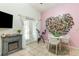 Bright dining area with tile floors, fireplace, and a modern table set at 1303 Azalea Way, Winter Garden, FL 34787