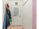 Bright entryway featuring a closet, tile flooring, and convenient coat rack at 1303 Azalea Way, Winter Garden, FL 34787