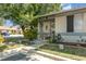 Single-story home featuring a cozy front yard with mature trees and a welcoming entrance at 1303 Azalea Way, Winter Garden, FL 34787