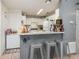 Efficient kitchen with bar seating, modern appliances, and ample cabinet space at 1303 Azalea Way, Winter Garden, FL 34787