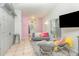 Open-concept living room with tile floors, comfortable seating, and a large window at 1303 Azalea Way, Winter Garden, FL 34787